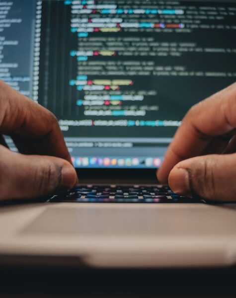 African American man sitting in front of computer coding, programming, web developer