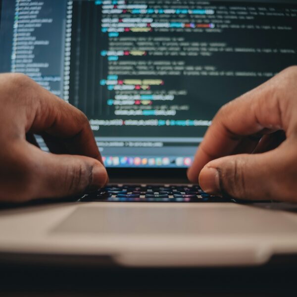 African American man sitting in front of computer coding, programming, web developer