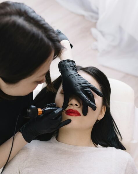 Professional beauty specialist applying permanent makeup