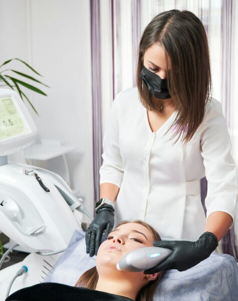 Woman receiving professional peeling in beauty salon.