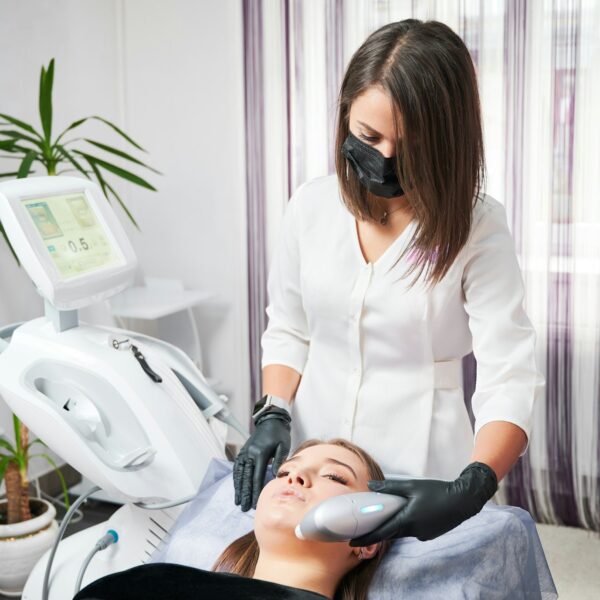 Woman receiving professional peeling in beauty salon.